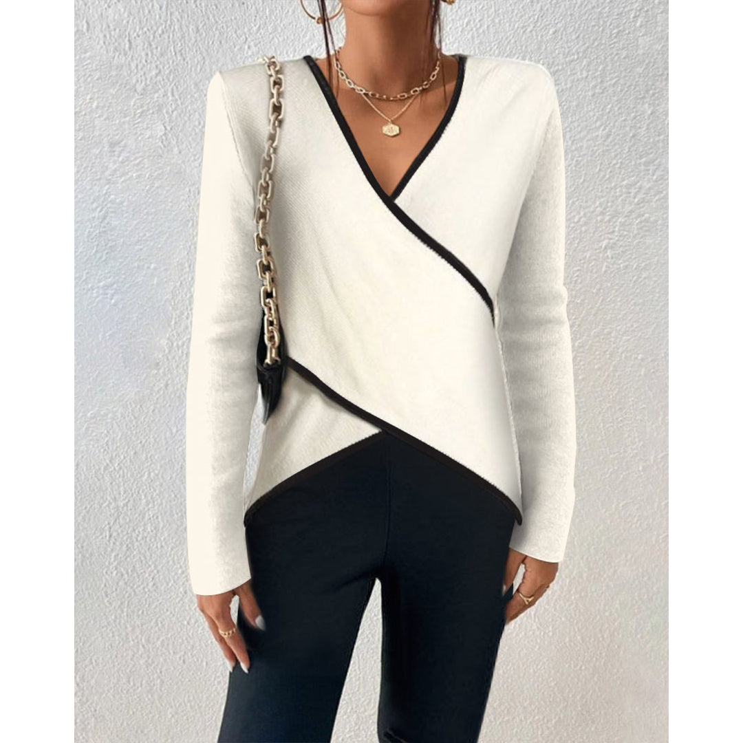 Women's cream wrap sweater styled with black trousers