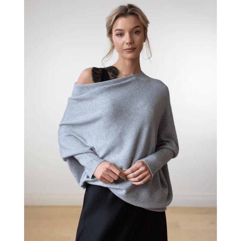 Women's light grey asymmetric knit poncho top worn off the shoulder