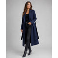Women's navy blue long coat worn open with black jeans and ankle boots