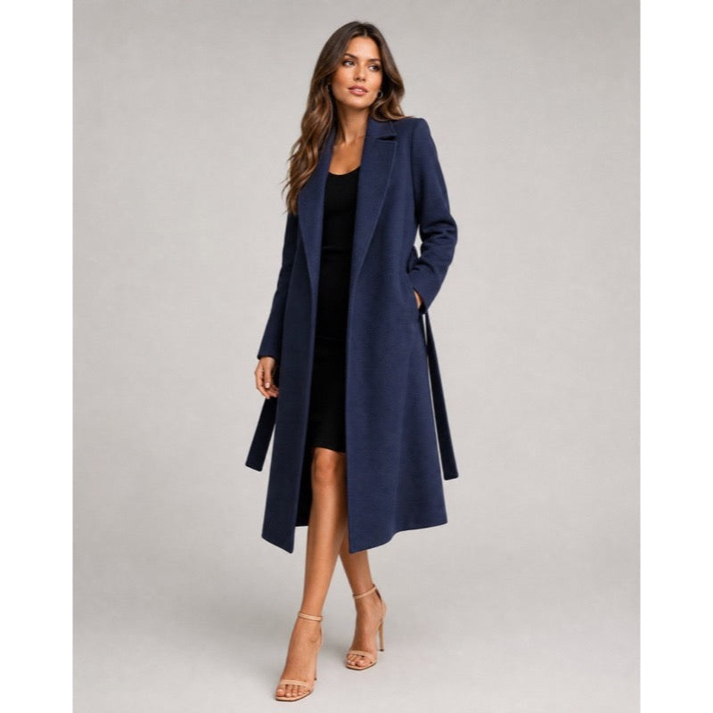 Navy blue longline coat with notched lapels worn over a black dress