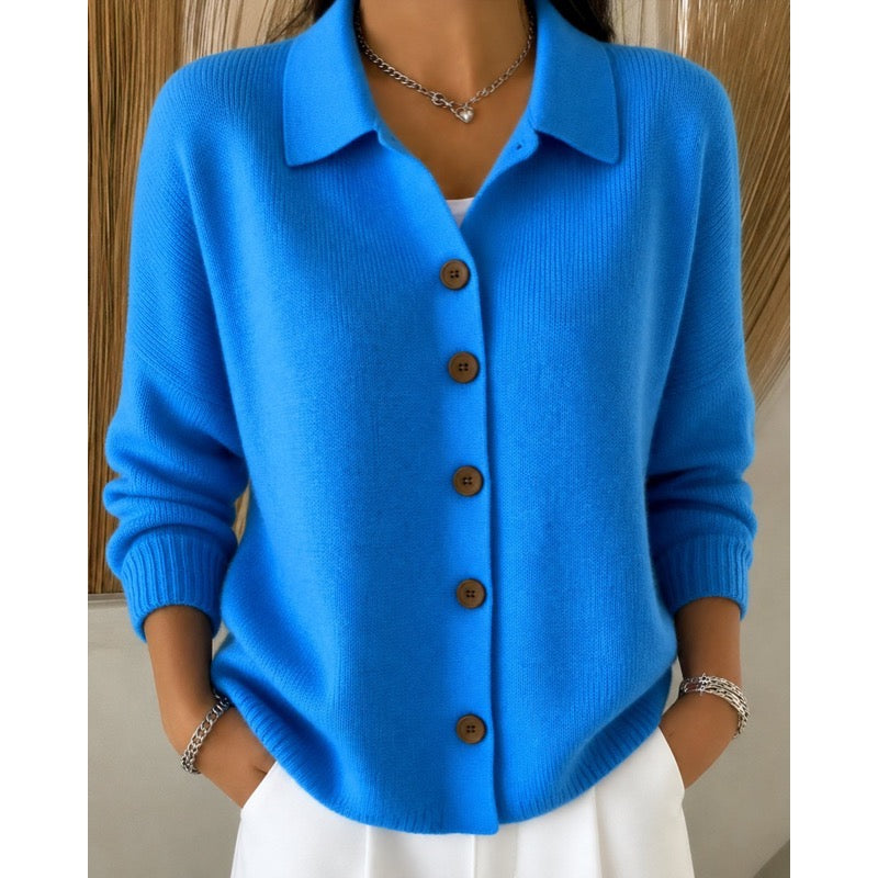 Women's blue collared button cardigan with white trousers