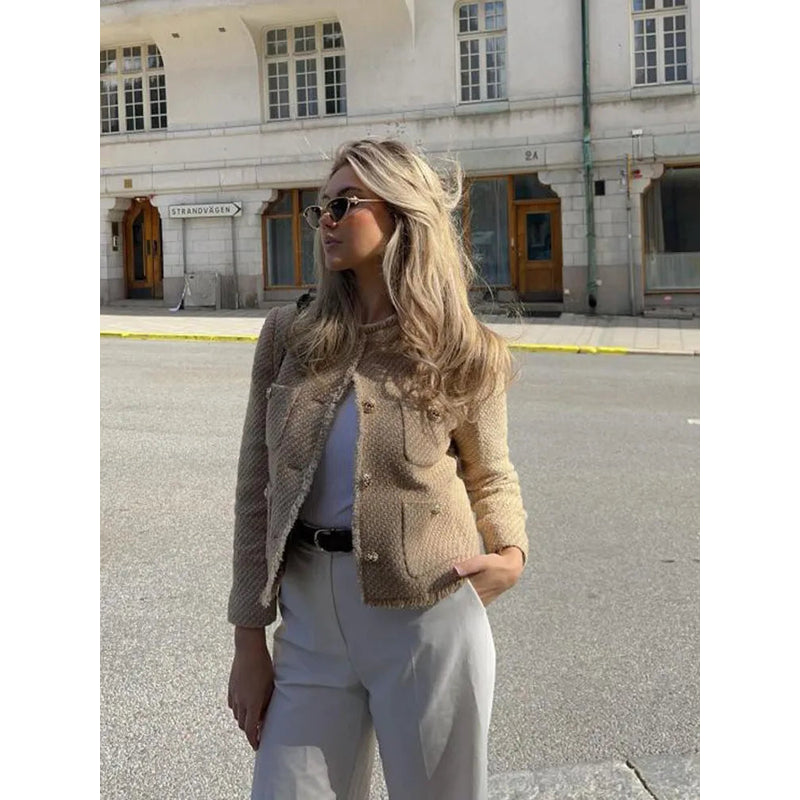 Woman in khaki cropped tweed jacket in the city