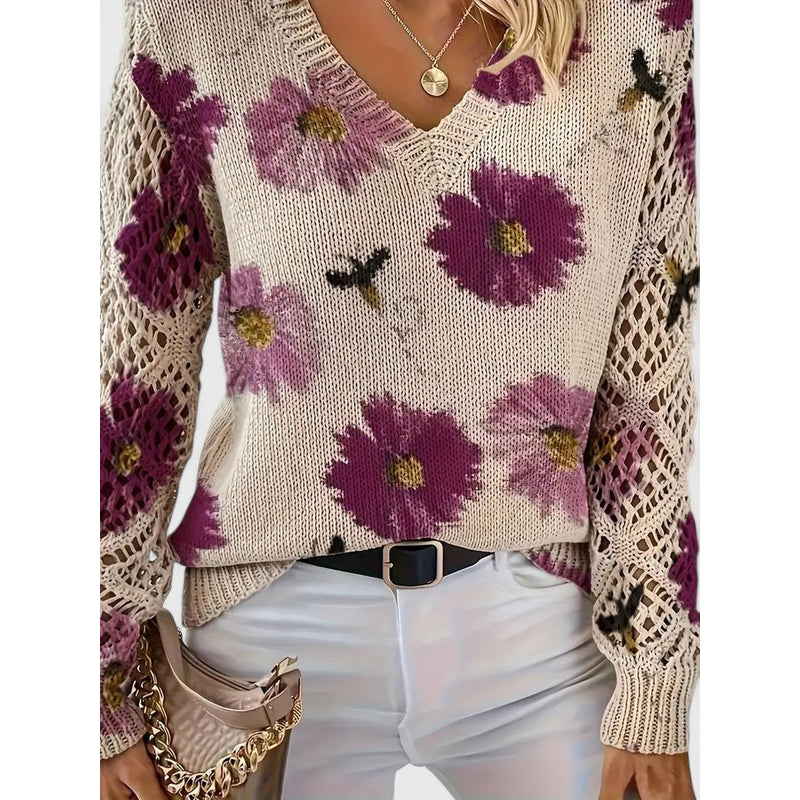 Close-up of purple floral knit sweater with openwork sleeves