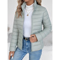 Women's sage green lightweight quilted jacket with stand collar and jeans