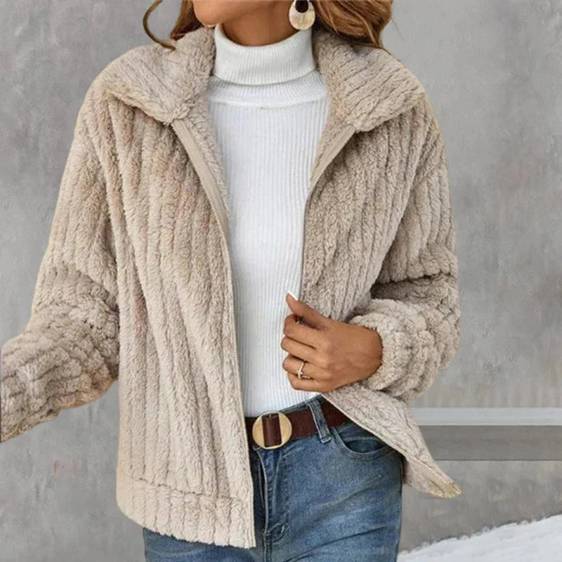 Women's beige plush zip-up jacket over a white roll-neck