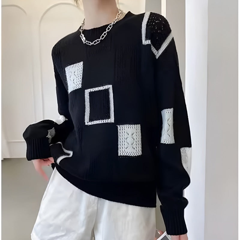 Black printed crew neck sweater worn with white trousers