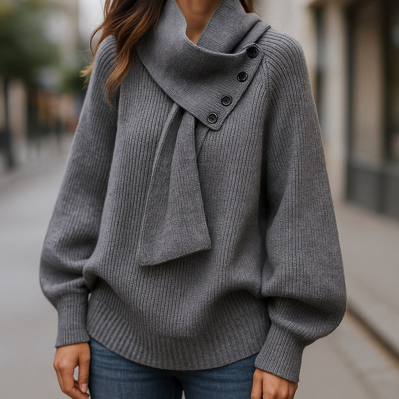 Woman wearing a grey shawl collar knit sweater with jeans