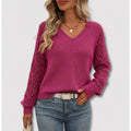 Women's hot pink V-neck sweater with open-knit sleeves and jeans